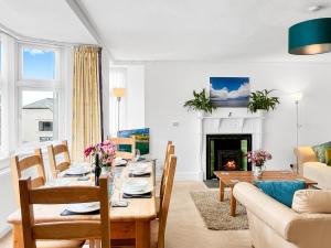 a living room with a table and a couch at Keld Apartment Porlock in Porlock