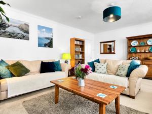 a living room with two couches and a coffee table at Keld Apartment Porlock in Porlock