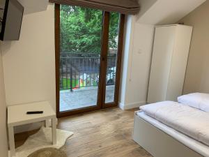 a bedroom with a bed and a large window at Skorzęcin Apartamenty Orla in Skorzęcin