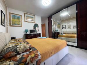 a bedroom with a bed and a large mirror at B&B Imagine in Bari