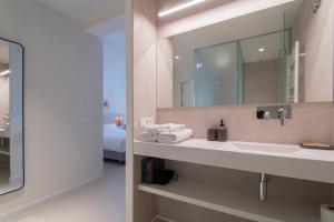 a bathroom with a sink and a mirror at Edificio Ferrari 4, by Plaza Mayor Apartamentos in Valladolid +72 photos