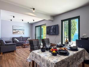 a living room with a table with food on it at Beachfront Villa San't Antonio Podaca in Podaca