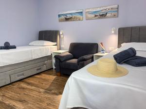 a room with two beds and a hat on a table at Beachfront Villa San't Antonio Podaca in Podaca
