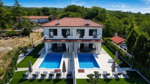 an aerial view of a house with two swimming pools at Villa Dijana with Pool - Sol Tours in Kras