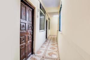 an empty hallway with a door and a tile floor at Hotel O Vira Palace in Mumbai
