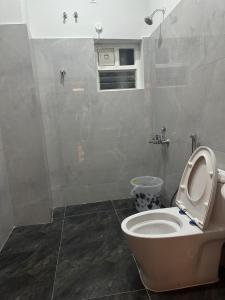 a bathroom with a white toilet and a shower at Hotel Siri Inn Hitech City in Hyderabad +52 photos
