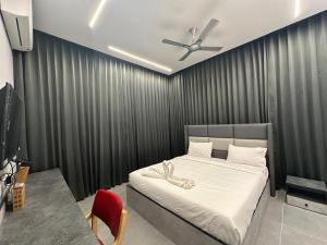 a bedroom with a bed with a ceiling fan at Hotel Siri Inn Hitech City in Hyderabad