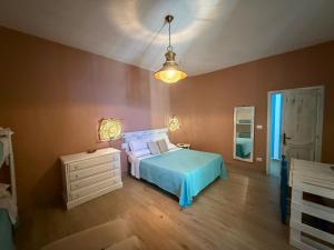 a bedroom with a bed and a dresser and a lamp at Civico 98 in Milazzo
