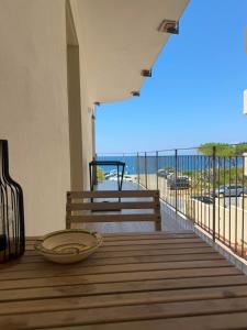 a balcony with a bench and a view of the ocean at Civico 98 in Milazzo