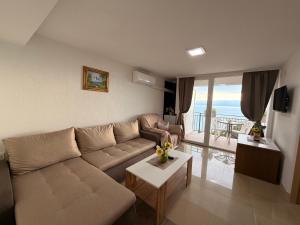 a living room with a couch and a table at NINAS Apartments in Elshani