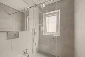 a bathroom with a shower with a glass door at Trafaria Bliss in Trafaria +18 photos