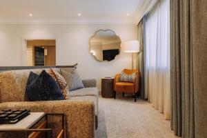 a living room with a couch and a chair at Skiddaw Hotel in Keswick