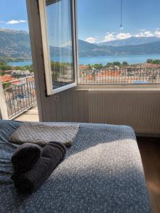 a bedroom with a bed and a large window at Skyline apartment Ioannina in Ioannina