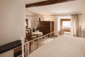 a bedroom with a bed and a dining room at Casa Due Marie Boutique stay near Modena & Maranello in Marano sul Panaro