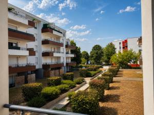 an apartment building with a row of bushes at La Beaujoire in Nantes