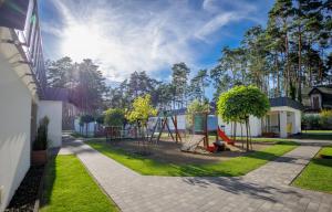 a playground in a yard with a swing at LABA Wieleń in Wielen Zaobrzanski