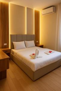 a bedroom with a bed with two swans on it at ImhOtep pYramids HOtel in Cairo