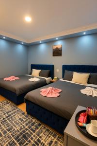 a room with two beds and a table at ImhOtep pYramids HOtel in Cairo