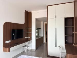 a living room with a desk and a tv at FryB in Phnom Penh