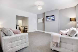 a living room with two couches and a tv at Stylish 2BR House in Ashington by Stay With Us in Ashington