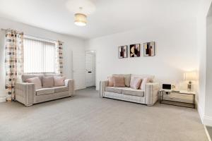 a living room with two chairs and a couch at Stylish 2BR House in Ashington by Stay With Us in Ashington