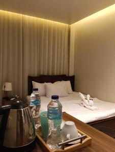 a hotel room with a bed and two water bottles on a table at ImhOtep pYramids HOtel in Cairo +52 photos