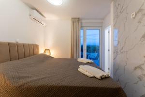 a bedroom with a bed with a view of the ocean at Kuća za odmor Leona in Dušić +96 photos