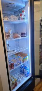 an open refrigerator filled with food and eggs at Gite Au P'tit Manoir B&B in Jonquiere