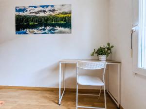 a desk with a chair and a painting on the wall at La Beaujoire in Nantes +12 photos