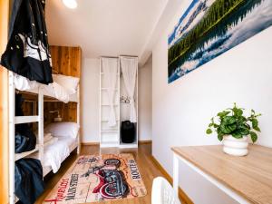 a small room with a bunk bed and a desk at La Beaujoire in Nantes
