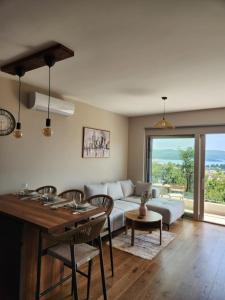 a living room with a couch and a table at Apartman Bloom 6 in Tivat