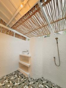 a bathroom with a shower and a sink at Bronze Bungalows in Gili Meno