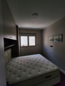 a bedroom with a bed in a room with a window at Apartman Bloom 6 in Tivat +29 photos