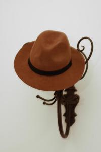 a brown cowboy hat sitting on a stand at Alt Wien in Vienna
