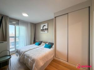 a bedroom with a bed with blue pillows at Altamar Imperial in Cabanes