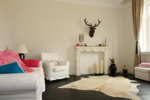 a living room with white furniture and a fireplace at Alt Wien in Vienna