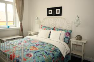 a bedroom with a bed with a floral bedspread at Alt Wien in Vienna