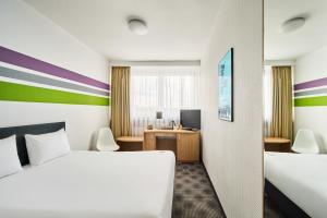 a hotel room with a bed and a desk at ibis Styles Bielsko Biala in Bielsko-Biała +152 photos