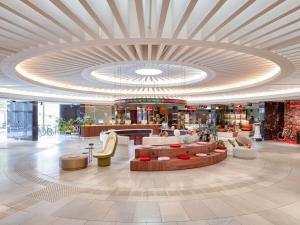 a lobby of a shopping mall with a large ceiling at 25hours Hotel The Circle in Cologne
