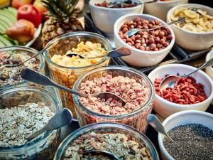 a table topped with jars filled with different types of food at 25hours Hotel The Circle in Cologne