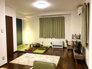a living room with a couch and a table at Hakodatekan - Vacation STAY 07899v in Hakodate