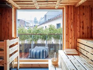 a room with a large window in a wooden house at 25hours Hotel The Royal Bavarian in Munich