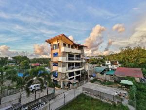 a tall apartment building in a city with a parking lot at Sea Break La Union in Balio +9 photos