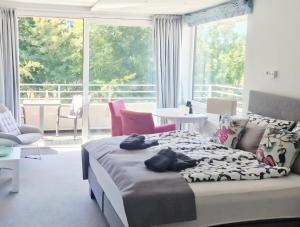 a bedroom with a bed and a large window at Apartment Sonnendeck in Ulstrupfeld
