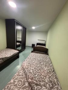 a room with two beds and a large rug at Staro Lane in Sjenica +7 photos