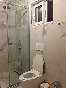 a bathroom with a toilet and a glass shower at Gregor Villa in Asim Zeneli
