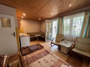 a bedroom with a bed and a chair in a room at Ośrodek Wypoczynkowy Lido Noclegi in Antonin