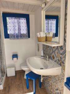 a bathroom with a sink and a toilet at Indigo Moon in Quartu SantʼElena +14 photos