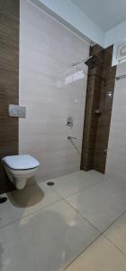 a bathroom with a toilet and a shower at Hotel KSR Grand in Srikalahasti