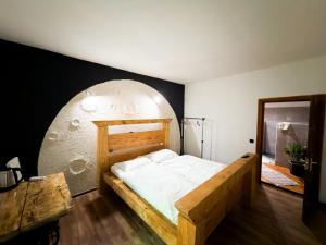 a bedroom with a wooden bed in a circular room at Suputnyk in Rakhiv